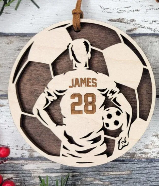 Personalized soccer ornament with player name James and number 28, laser engraved on wood